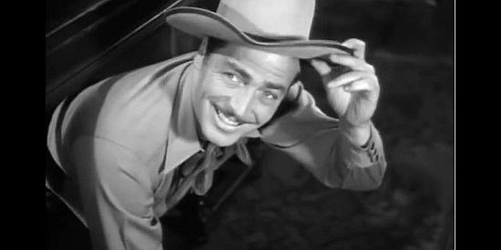 John Howard as Jim Kingston, popping out from under a desk when Ellen catches him snooping in Texas Rangers Ride Again (1940)