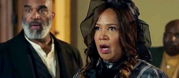 Kym Whitley as Sister Betty, reacting to the white women lie Tom Shealey is willing to spread to justify the destruction of Hope Springs in Outlaw Johnny Black (2023)