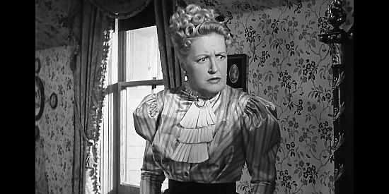 Lee Patrick as Melissa Price, annoyed at the way her hotel room is being shot up by a posse in The Doolins of Oklahoma (1949)