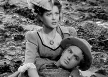 Ann Rutherford as Anne Grayson, fearing Jim Holliday (Robert Stack) has been struck by a stray bullet in Badlands of Dakota (1941)