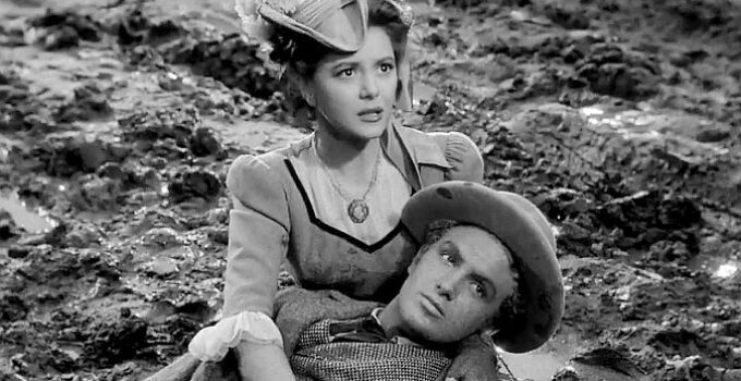 Ann Rutherford as Anne Grayson, fearing Jim Holliday (Robert Stack) has been struck by a stray bullet in Badlands of Dakota (1941)