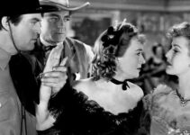 Chester Morris as David Cook and Buck Jones as Jim McDaniels look on as sisters Julie O'Conover (Ona Munson) and Phyllis (Anita Louise) spat in Wagons Westward (1940)