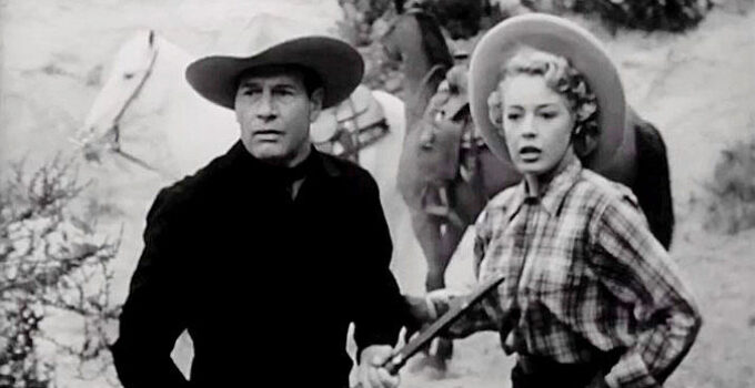 Richard Arlen as Dobe Williams and Mary Beth Hughes as Judy Marlowe, springing into action when a shot rings out in The Return of Wildfire (1948)