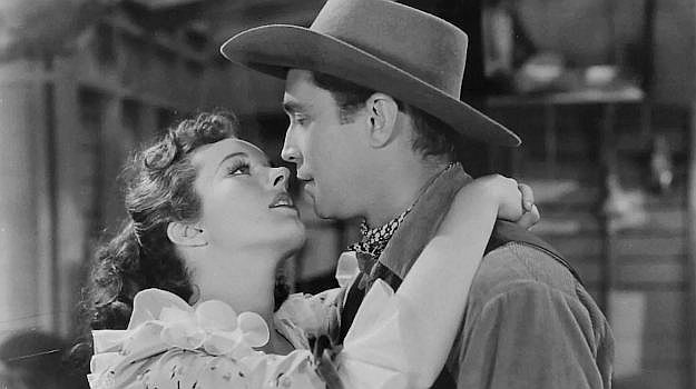 Peggy Moran as rancher's daughter Barbara Thornton using her charm on Tim Mason (Franchot Tone) in Trail of the Vigilantes (1940)