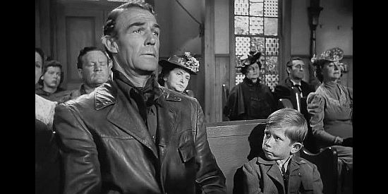 Randolph Scott as Bill Doolin, slipping into church to dodge the law and arousing the suspicion of a young church goer in The Doolins of Oklahoma (1949)