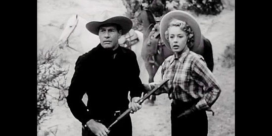 Richard Arlen as Dobe Williams and Mary Beth Hughes as Judy Marlowe, springing into action when a shot rings out in The Return of Wildfire (1948)