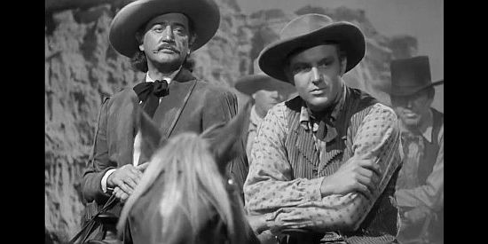 Richard Dix as Wild Bill Hickok and Robert Stack as Jim Holliday, waiting for 'Indians' to attack a stagecoach in Badlands of Dakota (1941)