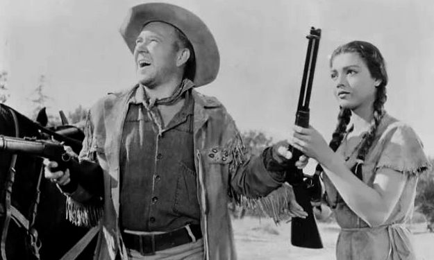 Richard Erdman as Rupe Pardee and Jana Davi as Keetah, 'borrowing' a couple of Winchester rifles in The Rawhide Trail (1958)