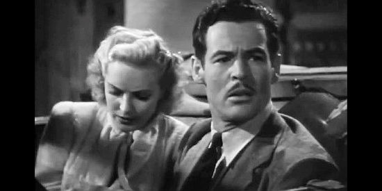 Robert Ryan as a citizen startled when a Texas Ranger badge lands in his lap in Texas Rangers Ride Again (1940)