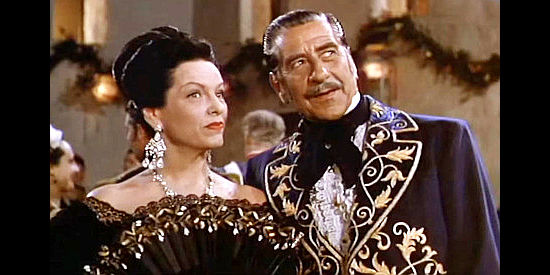 Robert Warwick as Gov. de Sola and Gale Sondergaard as his wife, hosting an engagement party for Marguerita and Carlos in Pirates of Monterey (1947)