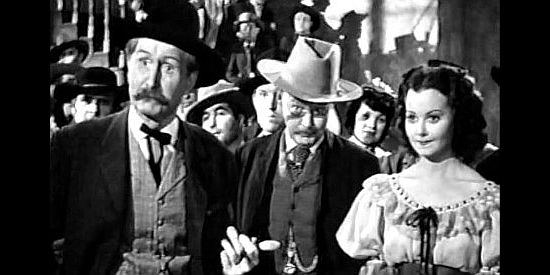 Russell Simpson as Mayor Potter, Don Beddoe as Hill and Adele Mara as Elena, wondering what Wellington is going to do about her father in Shut My Big Mouth (1942)