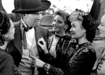 Bruce Cabot as Wild Bill Hickok, surrounded by grateful ladies, incluidng Constance Bennett as Belle Andrews, after stopping a runaway buckboard in Wild Bill Hickok Rides (1942)