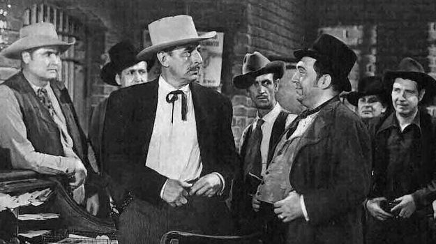 Douglas Dumbrille as Sheriff Hoskins getting information from town drunk McKenna (Thomas Gomez) in The Daltons Ride Again (1945)