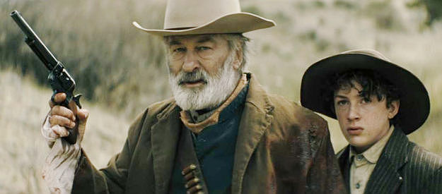 Alec Baldwin as Harland Rust and Patrick Scott McDermott as Lucas Hollister, facing trouble together in Rust (2024)