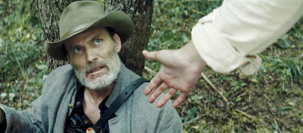 Casper Van Dien as Luke, wounded and offered a helping hand in Guns of Redemption (2025)