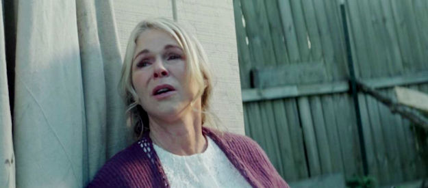 Kim DeLonghi as Beth Dyer, taking cover during a shootout in her husband's church in Guns of Redemption (2025)