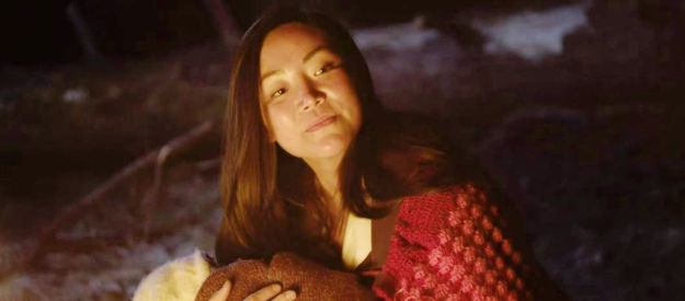 Aria Song as Willow Polly, enjoying a rare tranquil moment caring for baby Jane in Blood in Them Hills (2025)