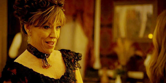 Forbes Riley as The Madam, encouraging Katie to take a job in her brothel in Black Creek (2024)