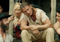 Claudio Del Falco as Django confers with his brother (Fabio Romagnolo) while friends listen in Django Undisputed (2025)