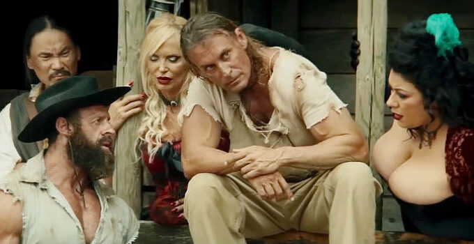 Claudio Del Falco as Django confers with his brother (Fabio Romagnolo) while friends listen in Django Undisputed (2025)