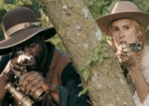 Gbenga Akinnagve as John Scobell and Rumer Willis as Katherine Atherton, approaching Col. Davis's homes in Trail of Vengeance (2025)