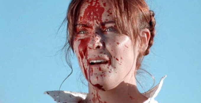 Sheri Rippel as Molly Pray, splattered in her husband's blood after a bounty hunter's visit in They Call Her Death (2025)