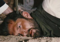 Tony Noto as the Thief, with a pistol to his temple in The Company of Thieves (2025)