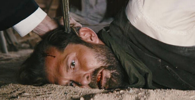 Tony Noto as the Thief, with a pistol to his temple in The Company of Thieves (2025)