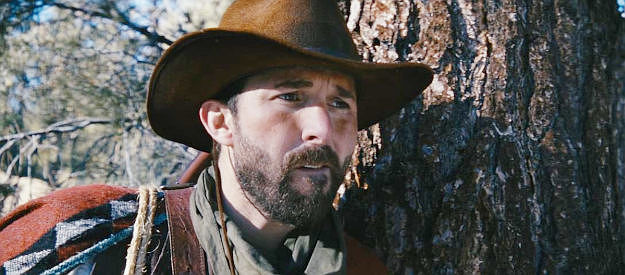 Tony Noto as the guitar-toting thief, spotting the town of Reno in the distance in The Company of Thieves (2025)