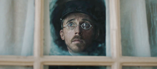 Benedict Hardie as Trooper Leslie, Sgt. Klintoff less-than-able assistant, watching his boss interact with Everton's finest in The Legend of Molly Johnson (2021)