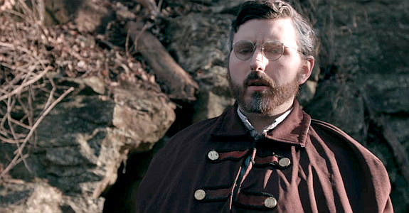 Bruce Robinson as a former college professor named Durrant, trying to turn a window into earth into a doorway in Demon's Vale (2024)