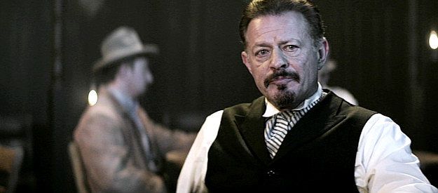 Costas Mandylor as Jericho, a town leader, learning about the posse headed toward Redemption in Gunslingers (2025)