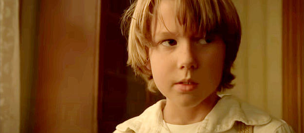 Jake Johnson, warily gazing at the attic door after hearing strange noises in The Attic Door (2009)