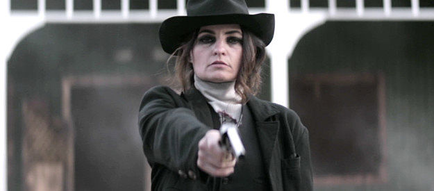 Laurie Love as Thalia, about to dispatch of a resident of Redemption in Gunslingers (2025)