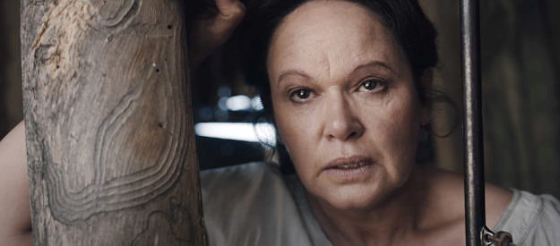 Leah Purcell as Molly Johnson, overcome with emotion after shooting a wild bull who threatens her children in The Legend of Molly Johnson (2021)