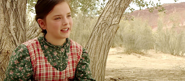 Madison Davenport as Caroline, reading another of her books in The Attic Door (2009)
