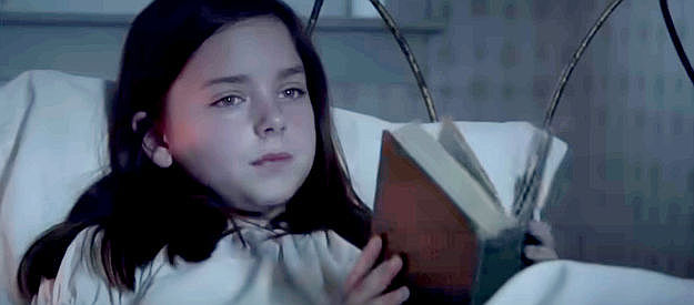 Madison Davenport as Caroline, reading another of her 'sad' books in The Attic Door (2009)