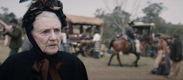 Maggie Dense as Shirley McGuiness, the pastor's wife, urging the new sergeant to clean up the debauchery in Everton in The Legend of Molly Johnson (2021)