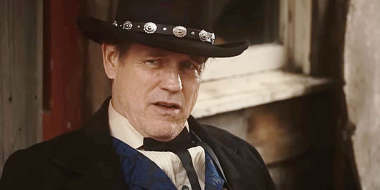 Michael Pare as Sheriff Sykes, hellbent on protecting his family's legacy in Bury 'Em Deep (20225)