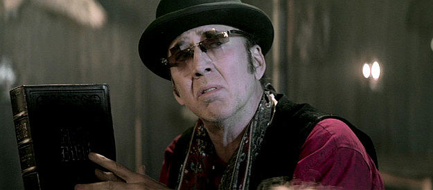 Nicholas Cage as Ben, reading the Bible again in Gunslingers (2025)