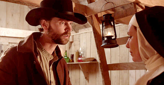 Scott Lucas as Owen Hayes, trying to convince Sister Martha of the need to leave the site of a deadly shootout in Demon's Vale (2024)