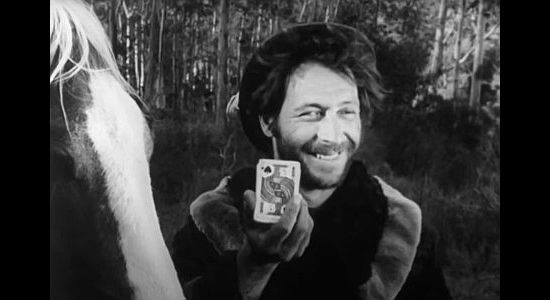 Jerald Cormier as Jubilo, happy with his card when the fur trappers draw to see who kills the woman in The Talisman (1966)