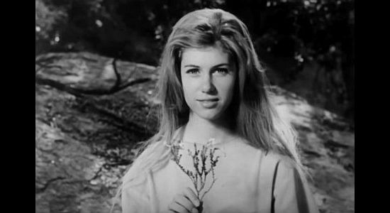 Linda Hawkins as the white woman, accepting flowers from the Cheyenne warrior leading her to safety in The Talisman (1966)