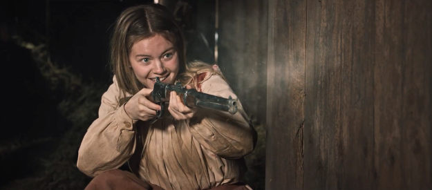 Brielle Robillard as Hester Meadows, thrilled to see one of her bullets find its mark in Place of Bones (2023)