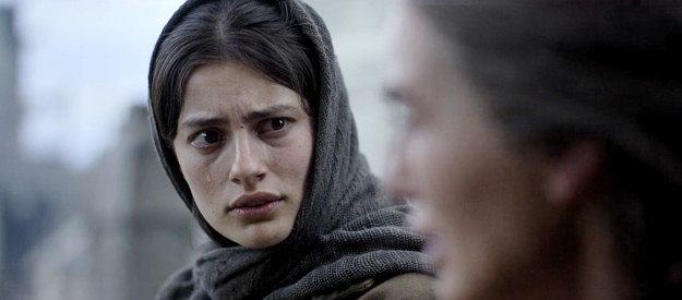 Diana Silvers as Dahlia Teller, wondering what Fiona is going to tell the priest during confession in The Abandons (2025)