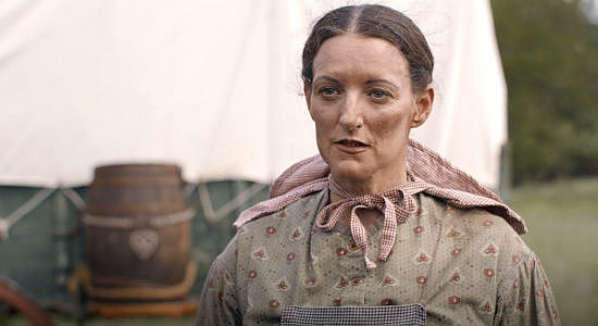 Dobie Brown as Rosa Ise, a newlyweb heading West with her husband and encountering a stranger on the trail in Sod & Stubble (2025)