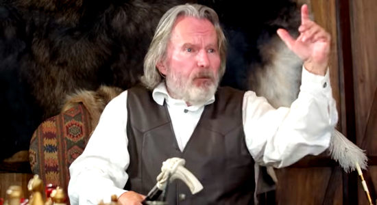 John Savage as Brad Braddock, a rich rancher upset that his ranch hands did much more than scare Consuela Reagan in Eye for and Eye (2022)