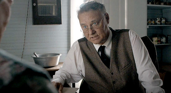 Mark Mannette as John Ile, trying to convince his mother to write down her memories of the pioneer days in Kansas in Sod & Stubble (2025)