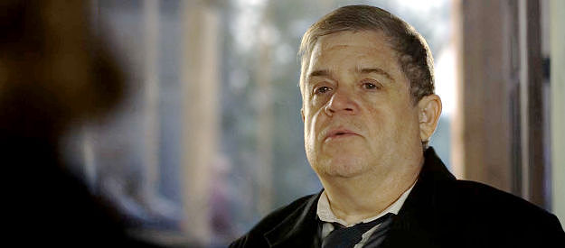 Patton Oswalt as Victor, mayor of Angel's Ridge, listening Constance Van Ness in The Abandons (2025)