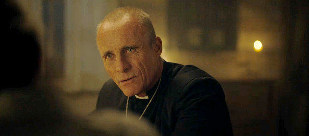 Timothy V. Murphy as the priest who takes confessions from Fiona Nolan and Dahlia Teller in The Abandons (2025)